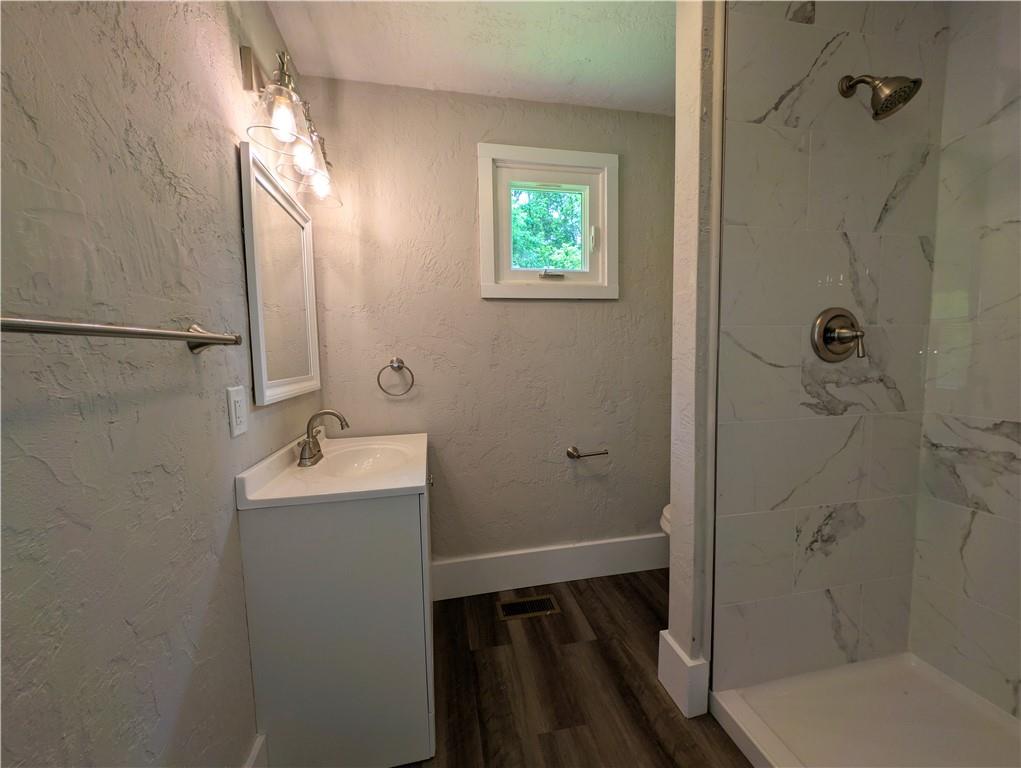 555 Steel Hill Road Mount Morris, PA 15349 - Photo 17 of 19 a bathroom with a sink and mirror with toilet