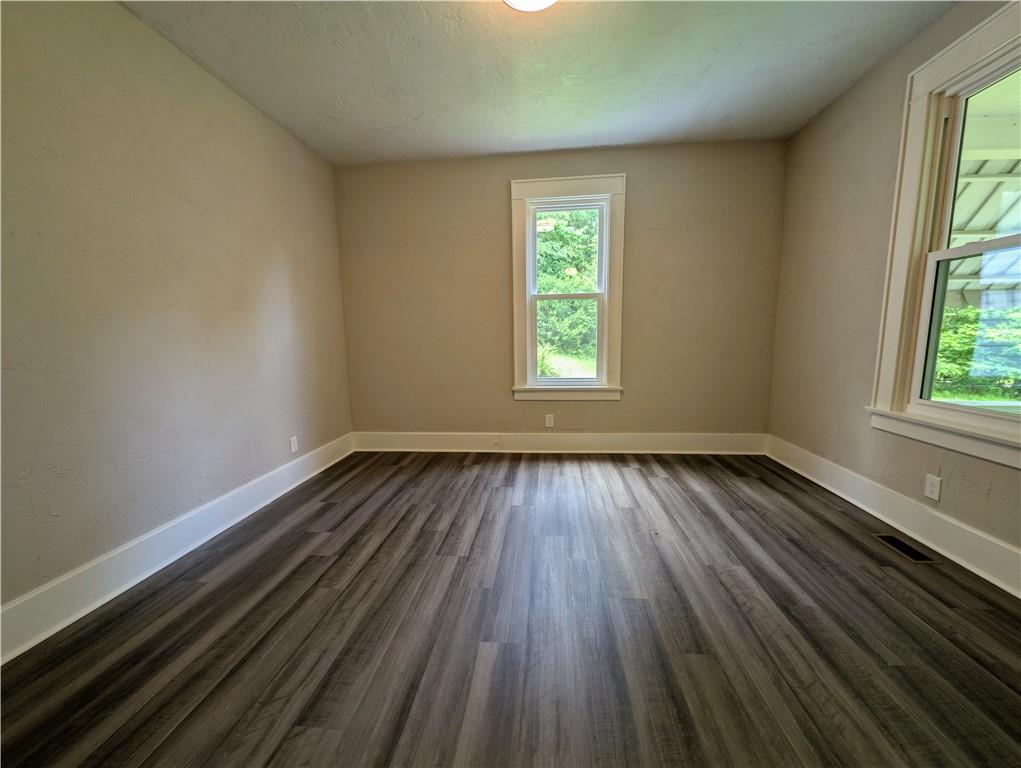 555 Steel Hill Road Mount Morris, PA 15349 - Photo 5 of 19 an empty room with wooden floor and windows
