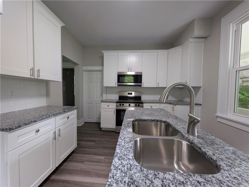 555 Steel Hill Road Mount Morris, PA 15349 - Photo 7 of 19 a kitchen with granite countertop a sink and a stove top oven