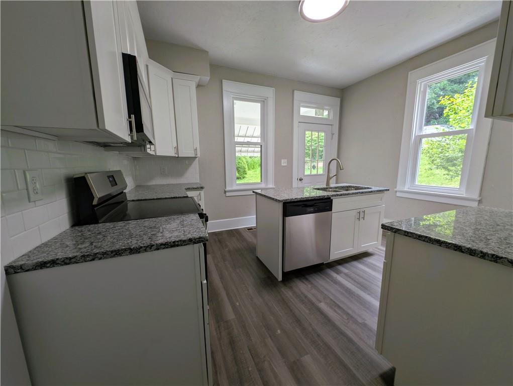 555 Steel Hill Road Mount Morris, PA 15349 - Photo 8 of 19 a kitchen with granite countertop a sink a counter space appliances and cabinets