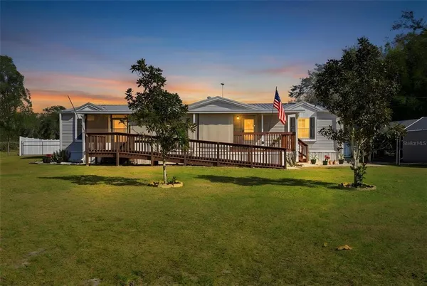 a front view of house with yard and seating area