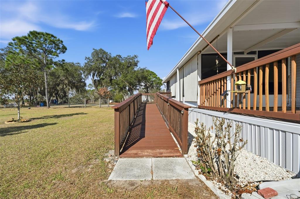 630 Otto Polk Road Frostproof, FL 33843 - Photo 11 of 44 a view of a pathway of a house with wooden stairs