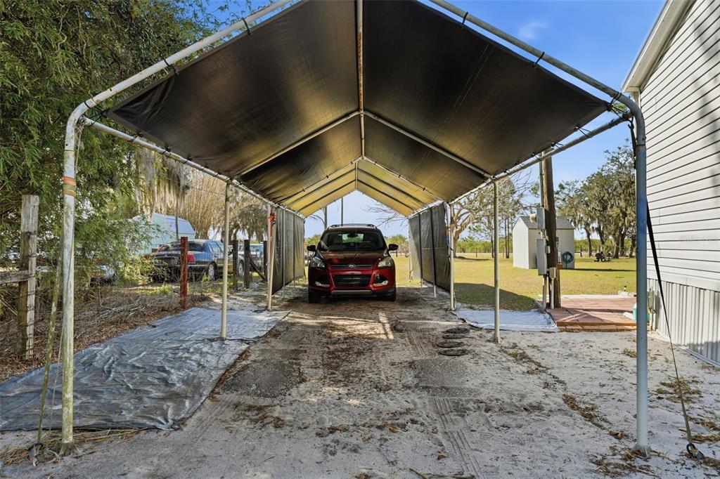 630 Otto Polk Road Frostproof, FL 33843 - Photo 16 of 44 a view of a car park in front of a house