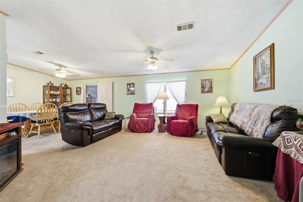630 Otto Polk Road Frostproof, FL 33843 - Photo 18 of 44 a living room with furniture a chandelier and a couch