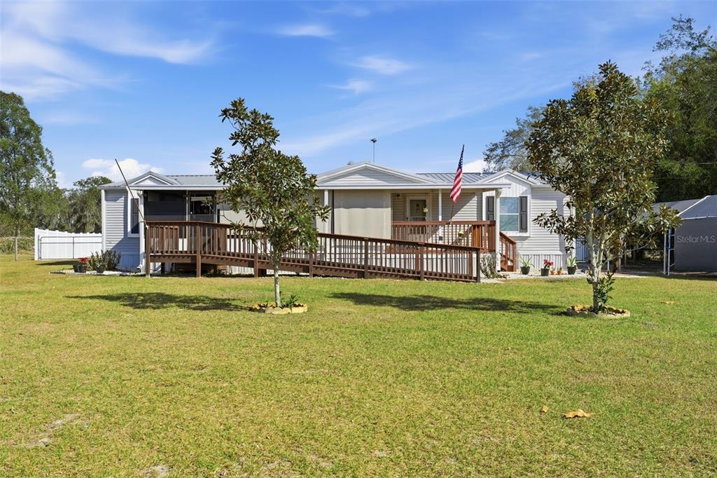630 Otto Polk Road Frostproof, FL 33843 - Photo 2 of 44 a view of a house with a big yard and potted plants