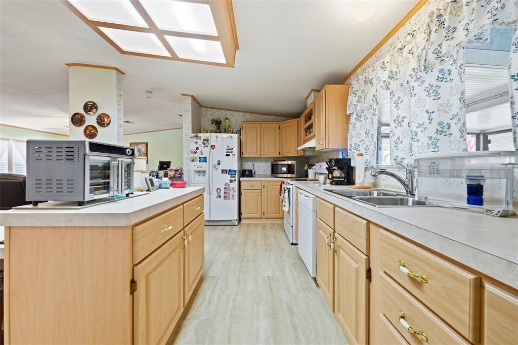 630 Otto Polk Road Frostproof, FL 33843 - Photo 25 of 44 a kitchen with cabinets appliances a sink and a window