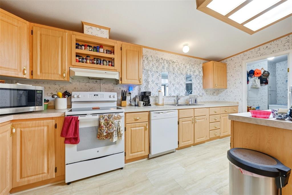 630 Otto Polk Road Frostproof, FL 33843 - Photo 26 of 44 a kitchen with stainless steel appliances granite countertop a sink and cabinets