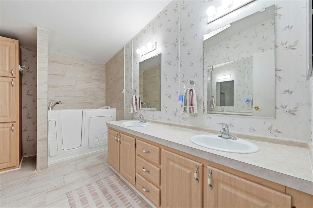 630 Otto Polk Road Frostproof, FL 33843 - Photo 27 of 44 a bathroom with a double vanity sink and mirror with shower