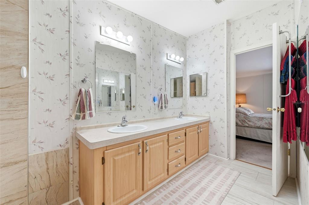 630 Otto Polk Road Frostproof, FL 33843 - Photo 33 of 44 a en suite bathroom with a sink and a mirror