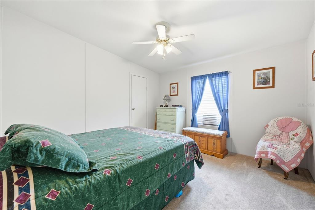 630 Otto Polk Road Frostproof, FL 33843 - Photo 36 of 44 a bedroom with a bed and a chandelier