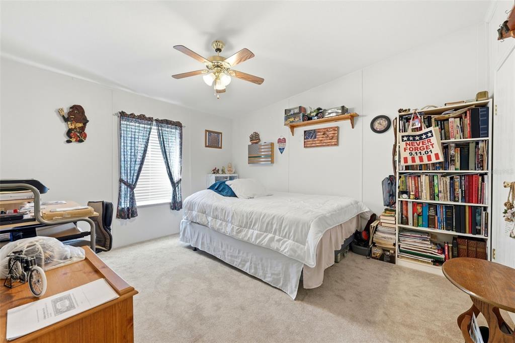 630 Otto Polk Road Frostproof, FL 33843 - Photo 41 of 44 a spacious bedroom with a bed and a book shelf