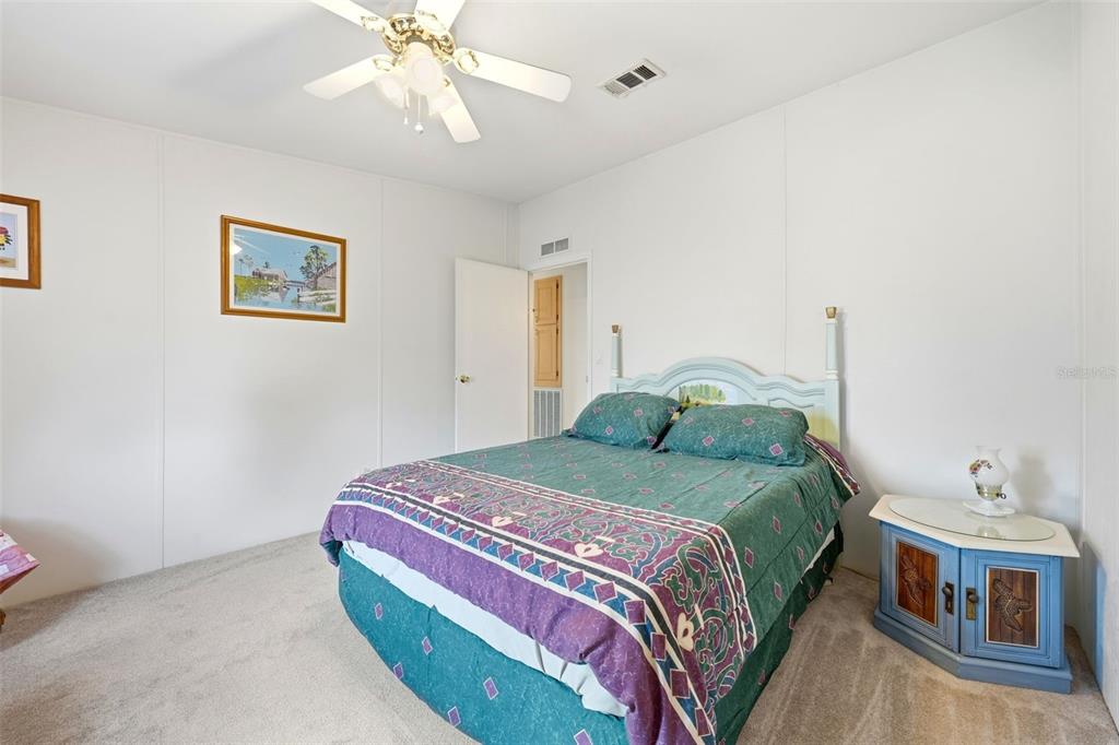 630 Otto Polk Road Frostproof, FL 33843 - Photo 42 of 44 a bedroom with a bed and a chandelier