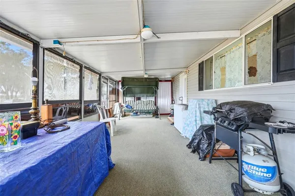 a view of living room filled with furniture and windows