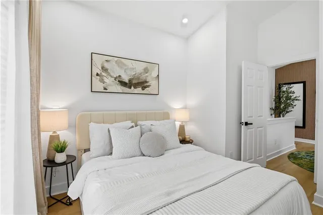 a bedroom with a bed and a painting on the wall