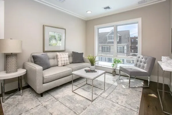 a living room with furniture and a large window