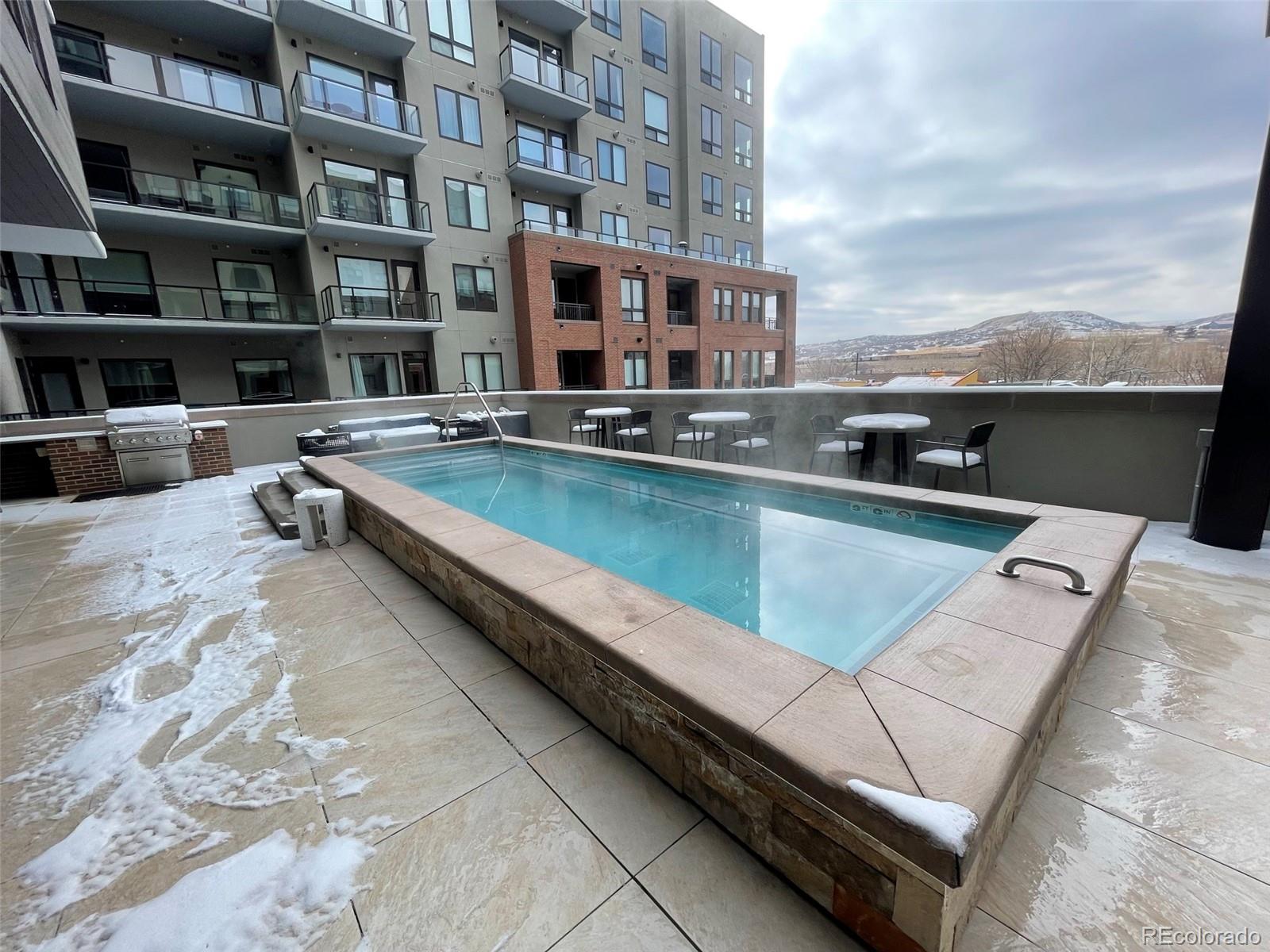 20 Wilcox Street, Unit 518 Castle Rock, CO 80104 - Photo 19 of 34 a view of swimming pool with outdoor seating and city view
