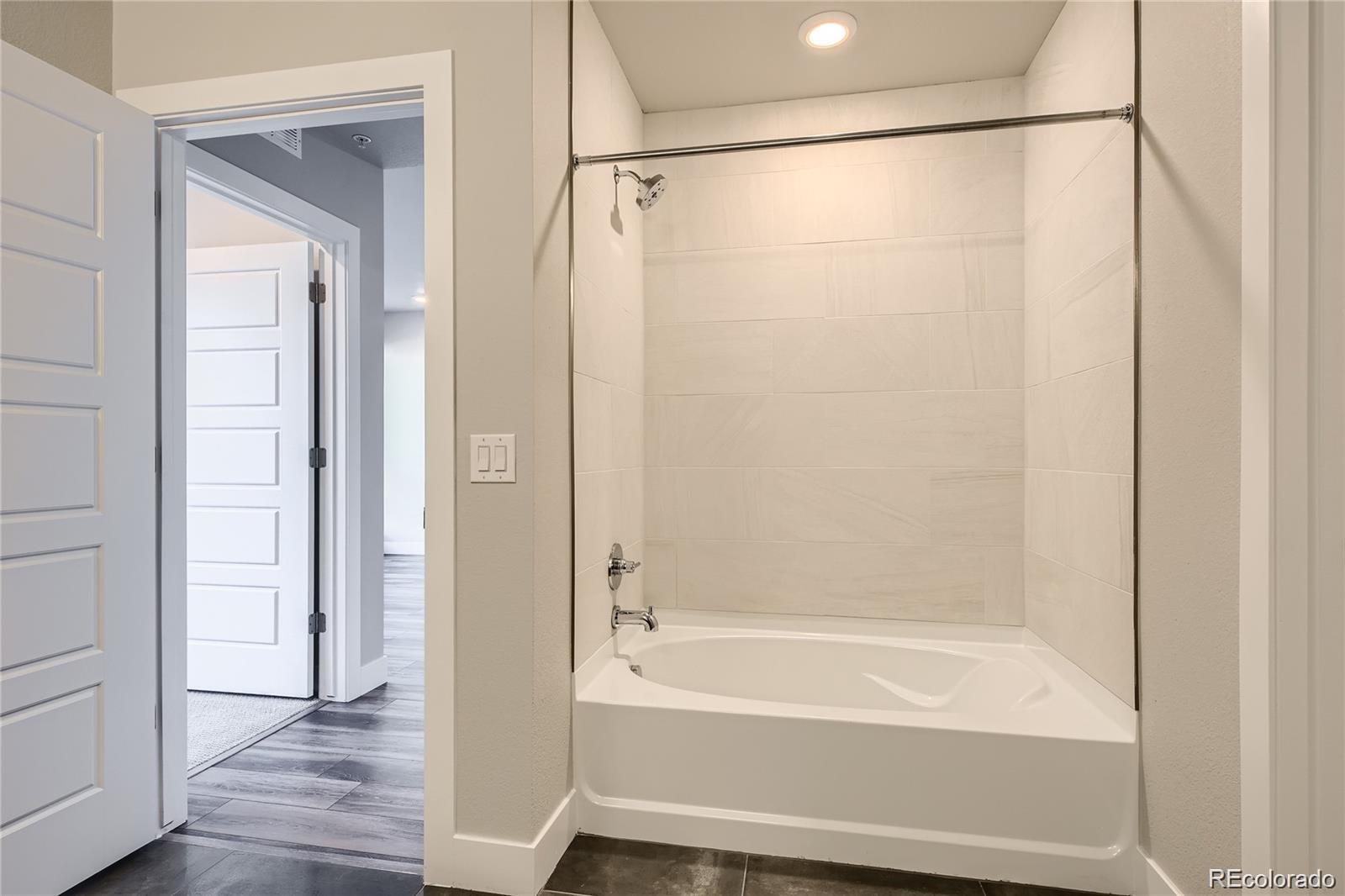 20 Wilcox Street, Unit 518 Castle Rock, CO 80104 - Photo 8 of 34 a bathroom with a bathtub and a shower