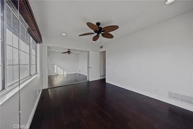a kitchen with kitchen island granite countertop wooden floors and a sink