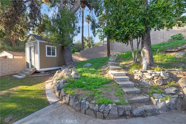 a kitchen with a stove and wooden floor
