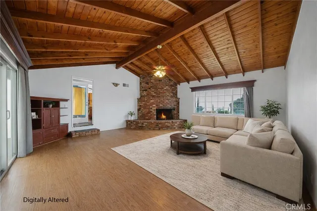 a view of an empty room with wooden floor and a ceiling fan