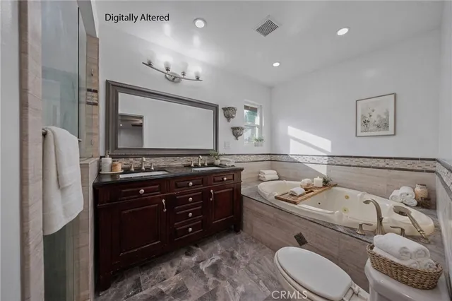 a bathroom with a granite countertop sink a toilet and mirror