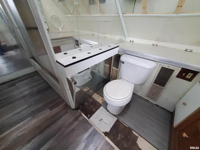 a white toilet sitting next to a bathroom sink
