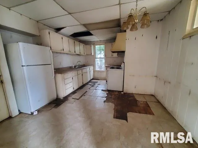 a kitchen with stainless steel appliances a refrigerator and a stove