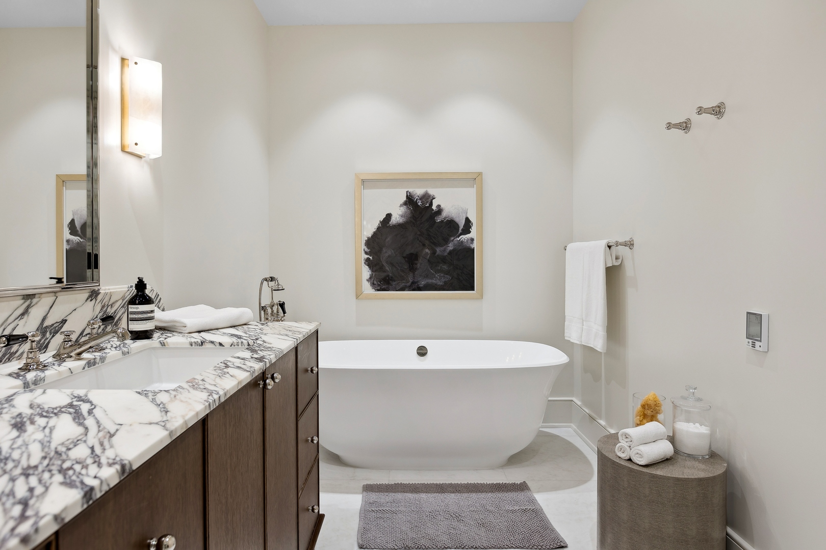 21 North May Street, Unit 602 Chicago, IL 60607 - Photo 33 of 39 a bathroom with a bathtub sink and mirror