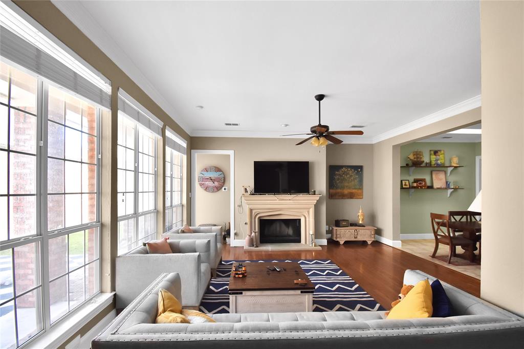 a living room with furniture a flat screen tv and a fireplace