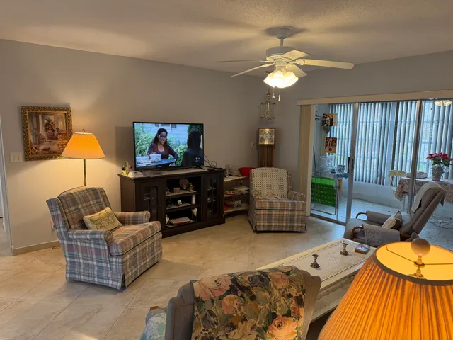 a living room with furniture a couch and a flat screen tv