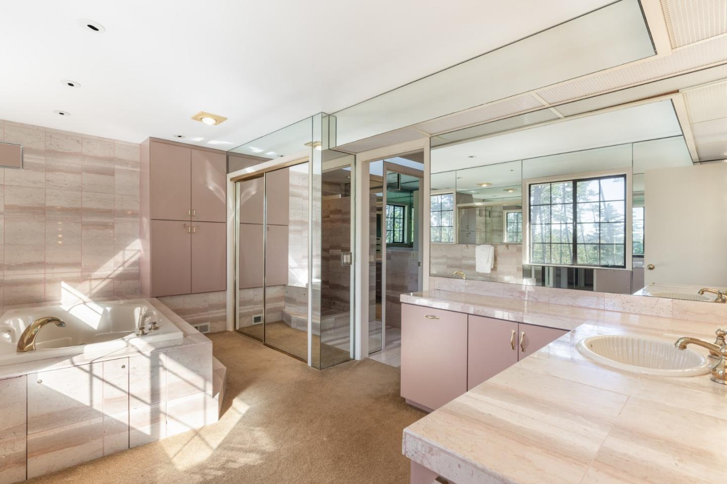 1424 Oleada Road Pebble Beach, CA 93953 - Photo 14 of 30 a bathroom with a sink and mirror with bathtub