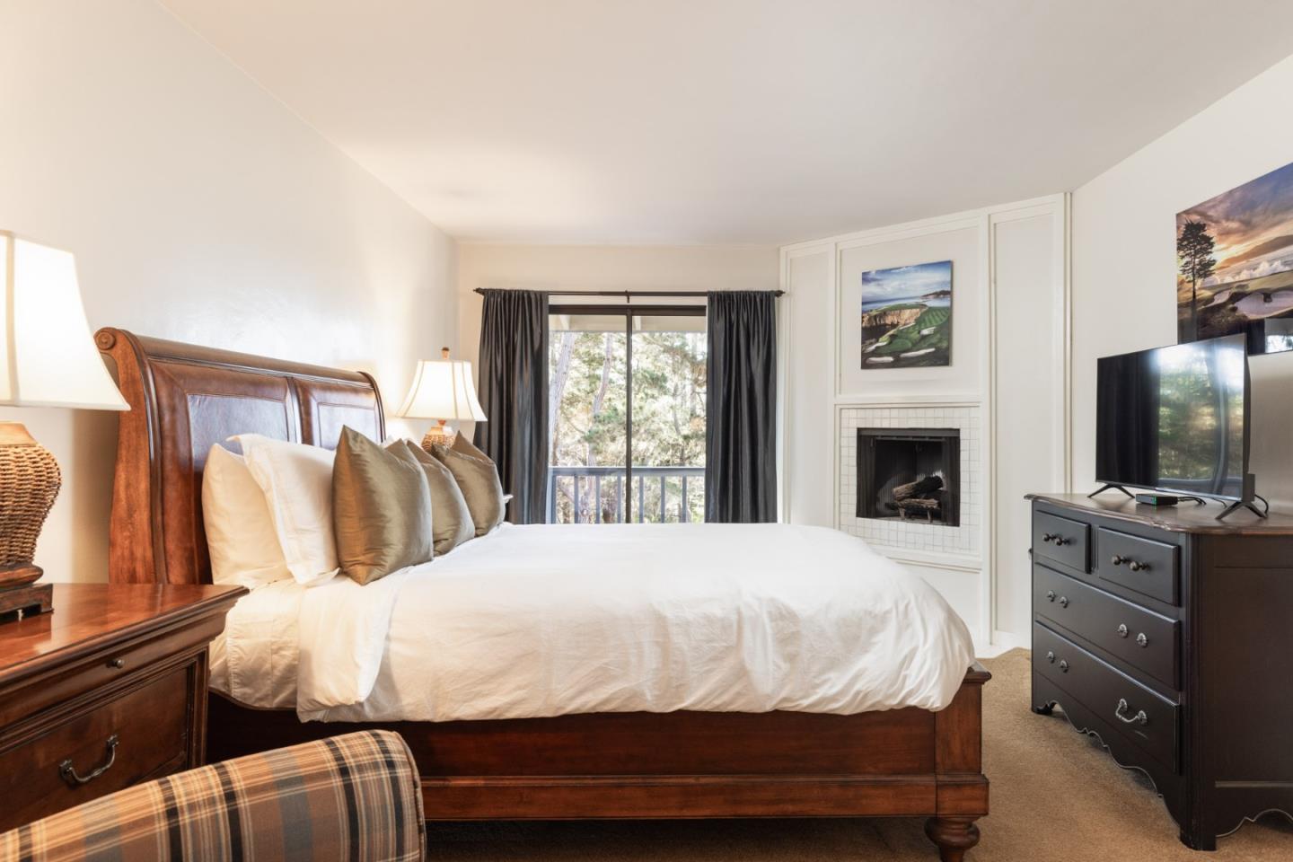 1424 Oleada Road Pebble Beach, CA 93953 - Photo 16 of 30 a bedroom with a bed and a flat screen tv