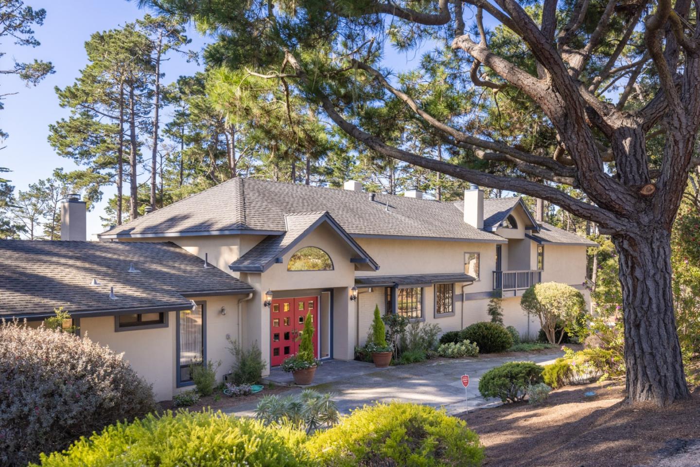 1424 Oleada Road Pebble Beach, CA 93953 - Photo 28 of 30 a front view of a house with a yard and potted plants