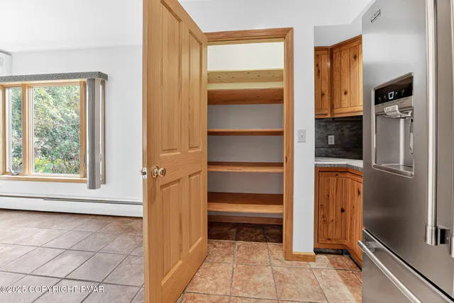 a view of walk in closet with empty racks