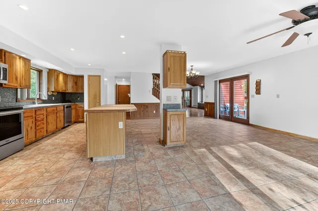 a view of kitchen with furniture and a refrigerator