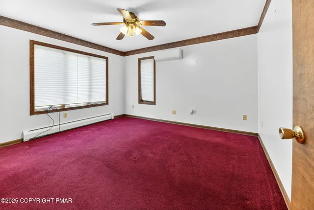 a view of room with window and ceiling fan