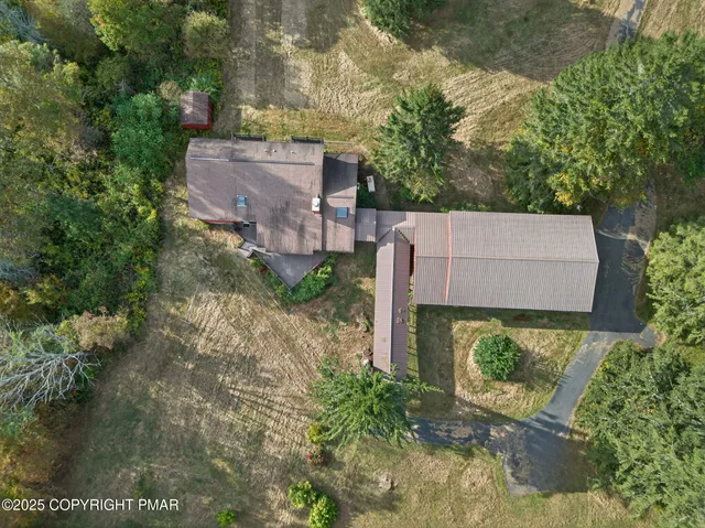 an aerial view of a house with a yard