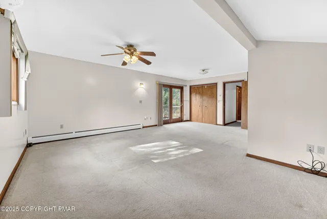 a view of empty room with ceiling fan