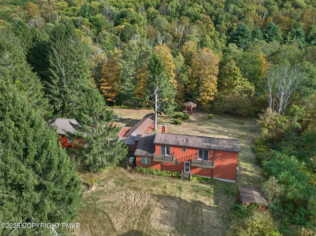 an aerial view of a house with a yard