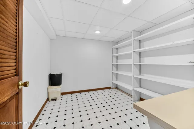 a bedroom with furniture and a rug