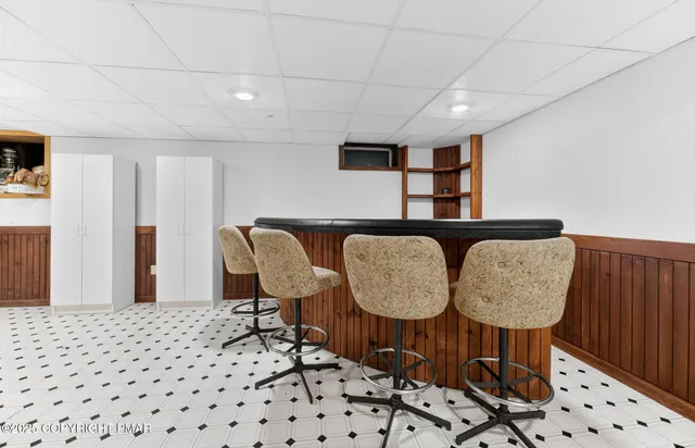 a bathroom with a refrigerator and a shower