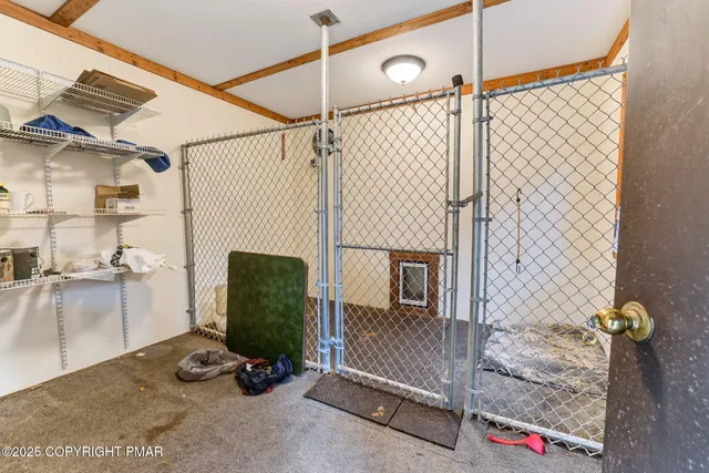 an aerial view of residential house with outdoor space and trees all around