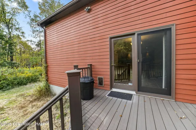 a view of a house with a yard and large tree