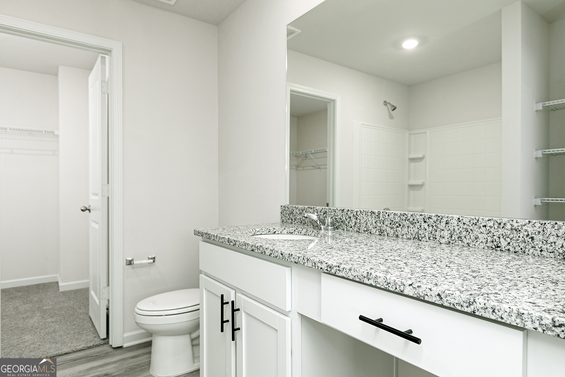 622 Mackenzie Cove Villa Rica, GA 30180 - Photo 11 of 14 a bathroom with a granite countertop sink a toilet and a shower