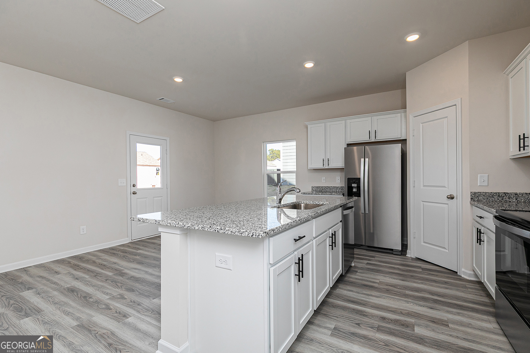 622 Mackenzie Cove Villa Rica, GA 30180 - Photo 7 of 14 a kitchen with stainless steel appliances granite countertop a sink stove and refrigerator