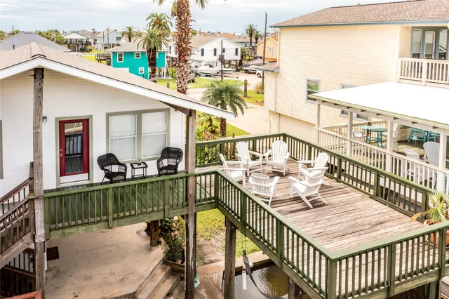 a view of a balcony with dining table and chairs