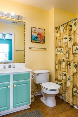 a bathroom with a toilet a sink and shower