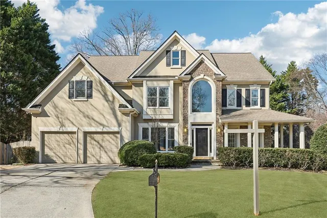 a front view of a house with a yard