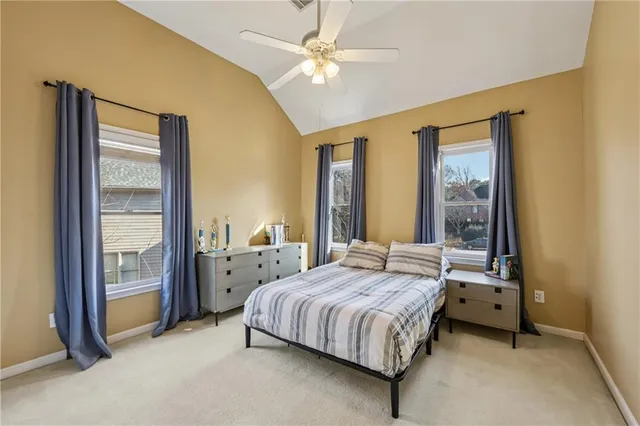 a living room with furniture ceiling fan and a window