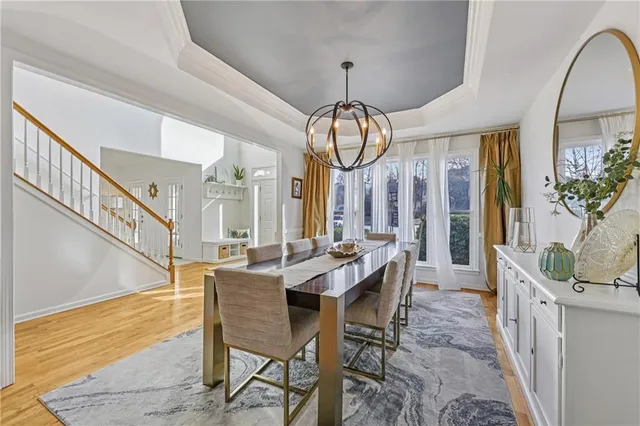 a view of a dining room with furniture wooden floor and a chandelier